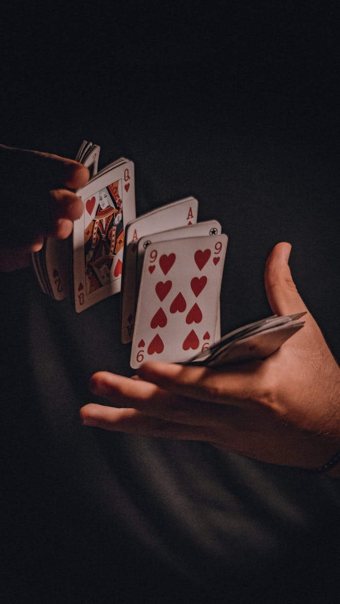 A dramatic close-up of hands skillfully shuffling a deck of playing cards.